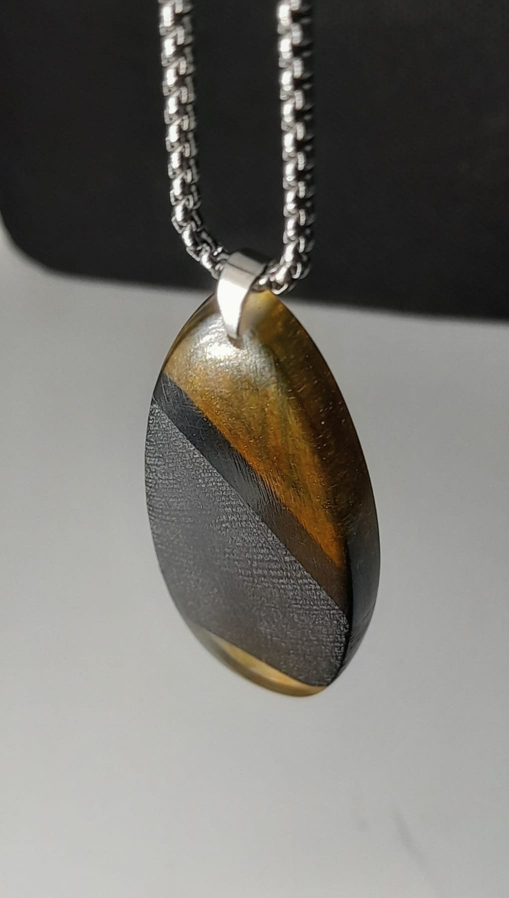 Bog oak and resin oval pendant on titanium chain